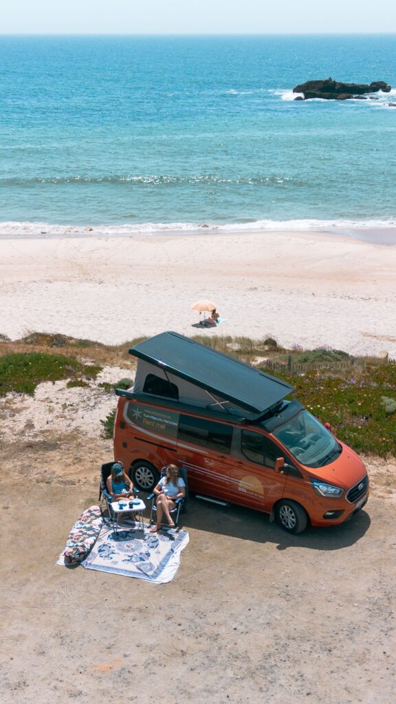 Camper Parked On Beach with Table